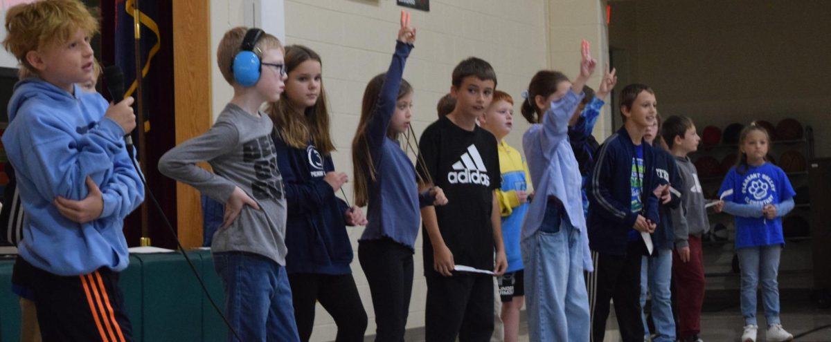 Silent moment. Fourth graders start symbolizing what they call the 'silent coyote' to help the teachers quiet the other students.The students learned various things at this assembly. 