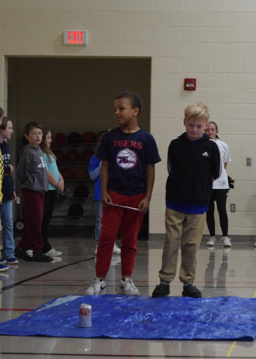 Teamwork. The fourth graders use a tarp and a can of soda to demonstrate controlling their feelings. This was one of several demonstrations put on. 