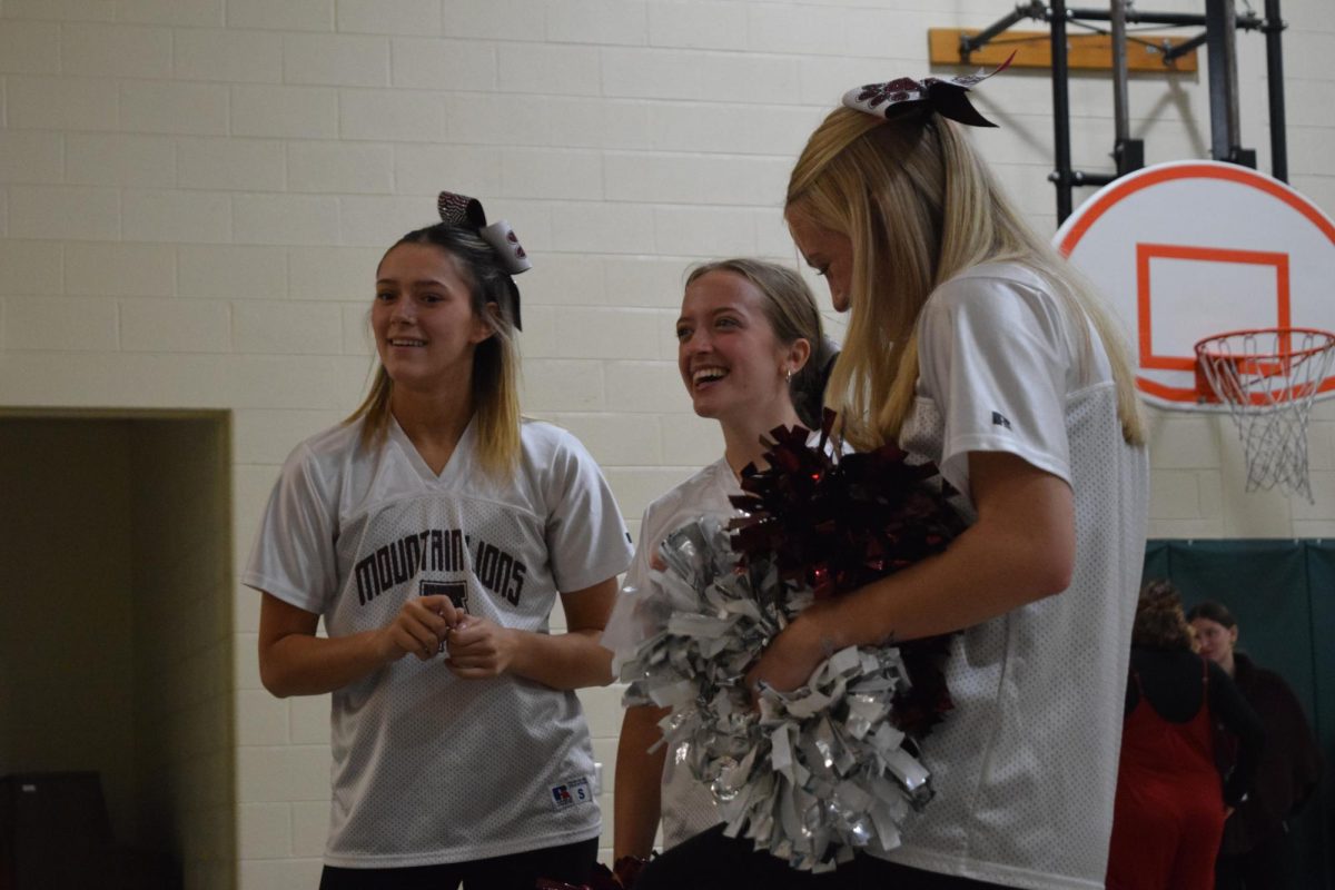 Wilt and Reed have fun as they watch the teachers and students playing cornhole. They enjoyed spending time with the elementary students. 