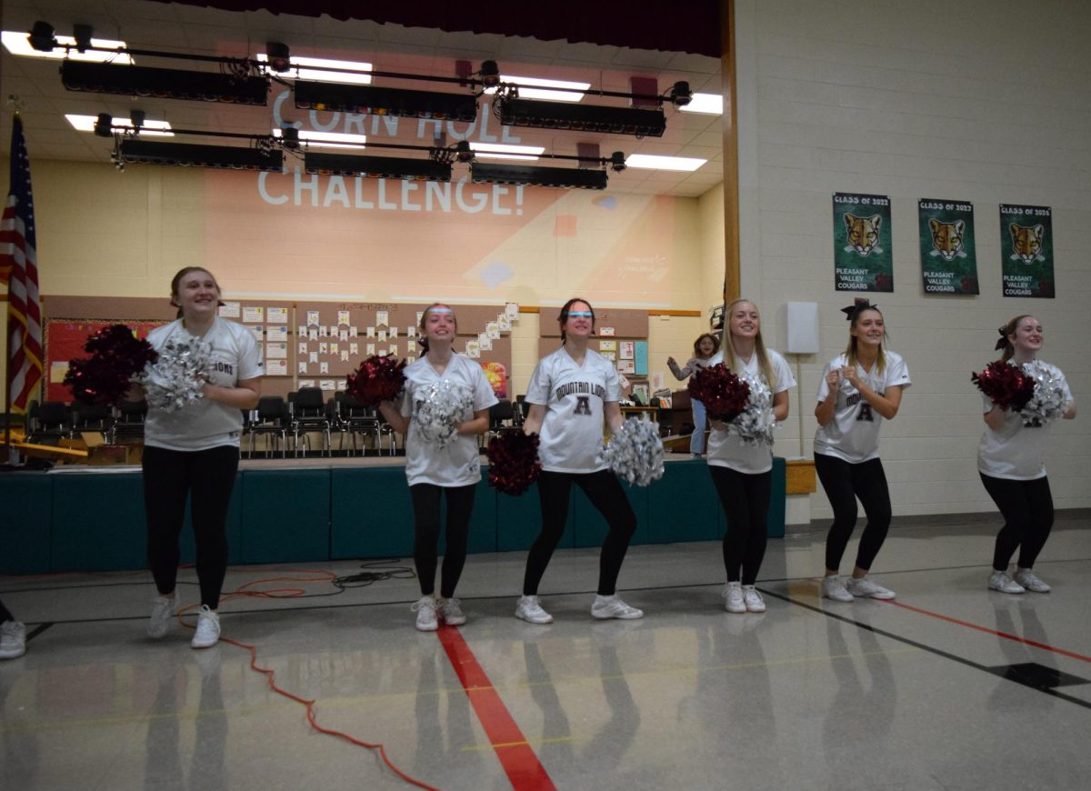 Cheering away. Laura Reed, Hailey Woomer, Baylin Smith, Brynley Rouzer, Kenzie Wilt, and Kinsley Palilla encouraged students during their performance. 