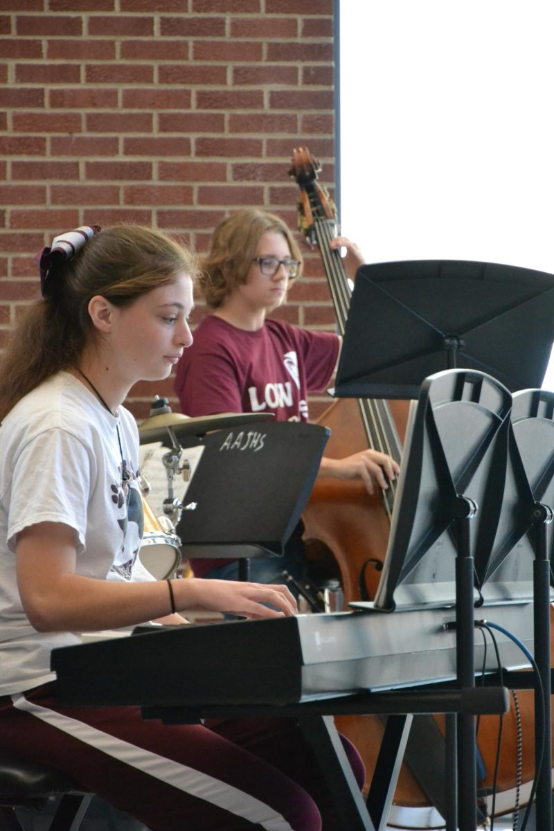 Focused in. Juniors Isabella Abbott and Andrew Sackett focus in on their music during practice. 