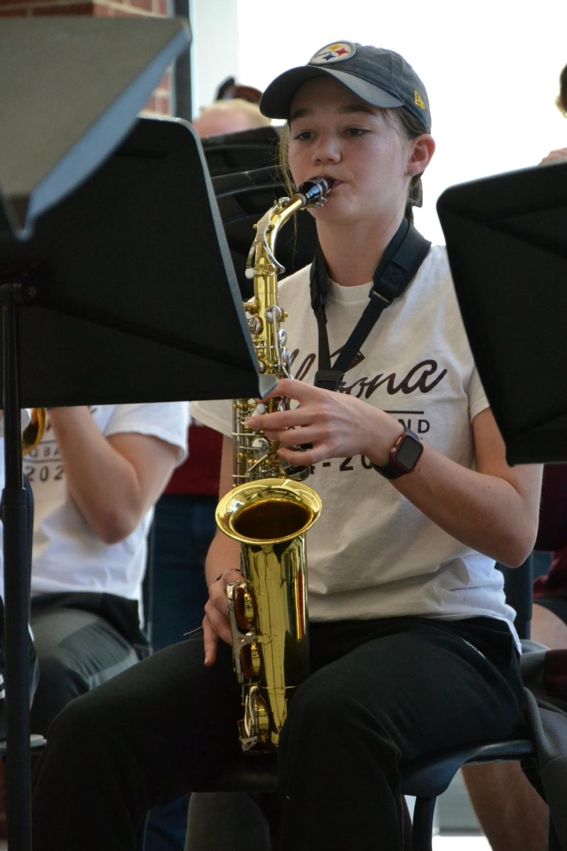 Read through. Junior Sage Bower focuses on her music while performing for the Navy Commodores. 