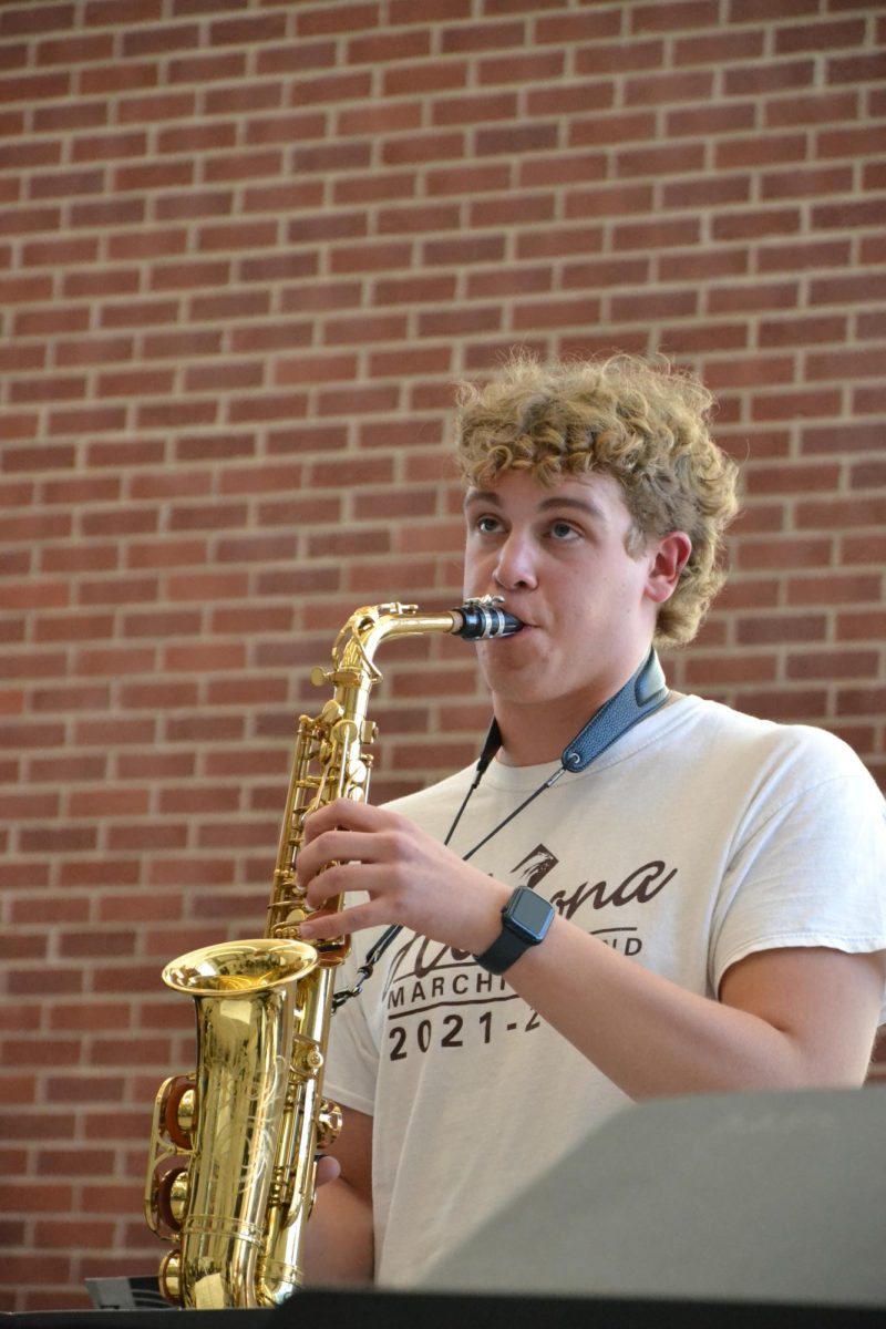 Solo. Senior Seth Goheen stands to perform his solo during practice. 