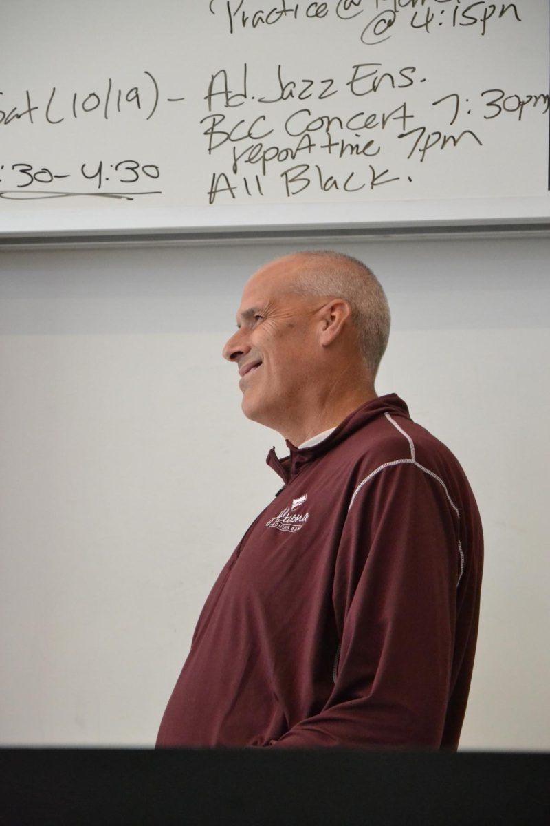 A proud moment. Advanced Jazz Ensemble director Larry Detwiler cracks a smile as he watches the ensemble perform.