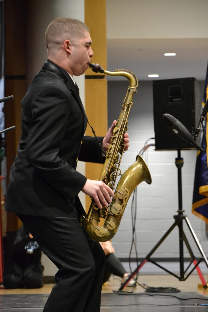 Working hard or hardly working. Many of the Navy Commodores performed solos throughout their performance for the music students. 