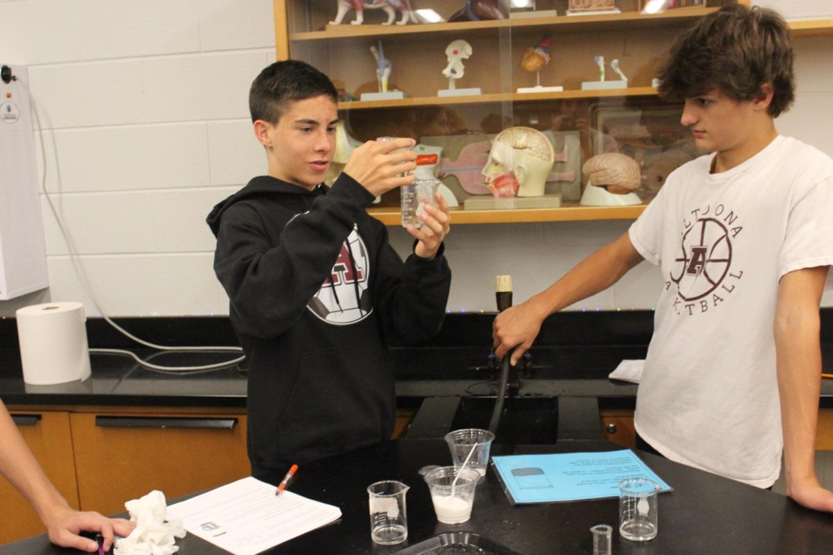 Freshmen Elijah Gibson and Hunter Kling work together, observing and collecting data.