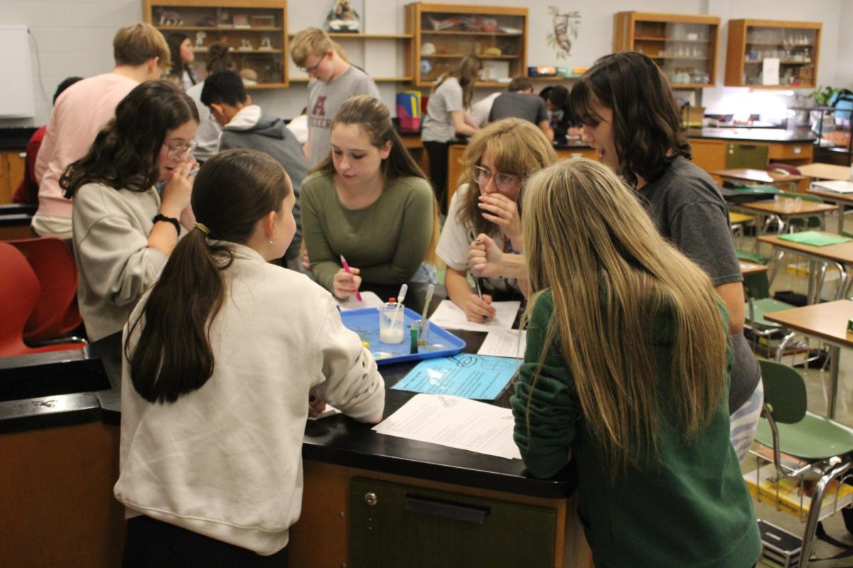 Freshmen Nora Beechum, Addison Heetan, Grace Murphy and Carmen Serrano stay studious while conducting a lab experiment.