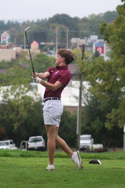 Swinging through, William Sankey throws a dart into a par three. 