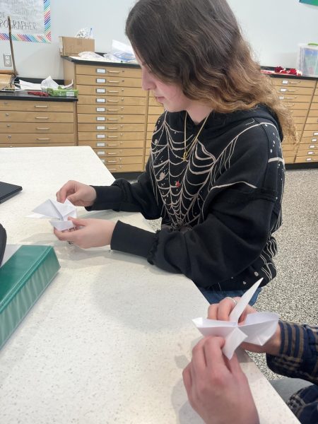 Senior Ava Mika works on creating origami doves during her art class. Any student is welcome to partake. 