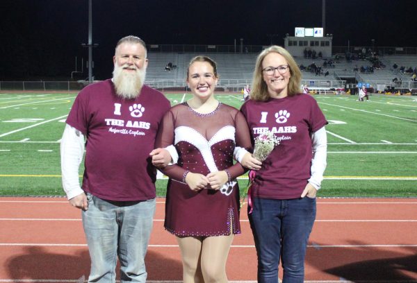 Majorette captain Jillian Pierannunzio poses with her escorts. 