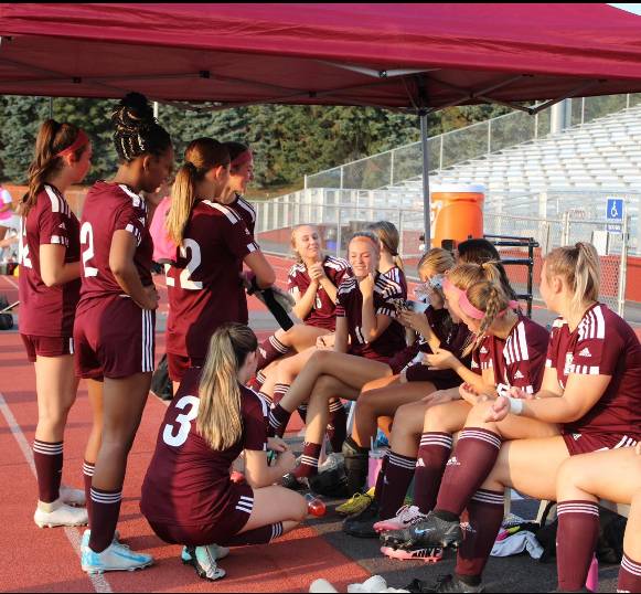 Team Bonding. The girls' soccer team talks about the week's previous game. (Courtesy of Sophia O'Dea)