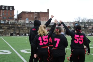 Game on! The team gathers, focusing and getting fired up for victory. The game will be played on the Roosevelt field this year instead of the IM field. 

(Courtesy of Charlie Kephart)