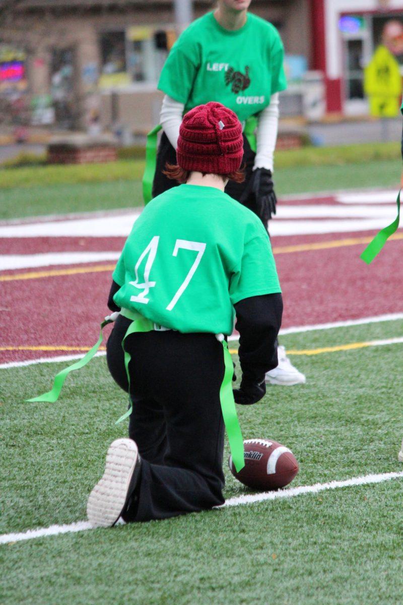 Getting ready. Junior Camille Krug holds the ball in place, waiting for her teammate to kick it. Krug played for The Leftovers, composed  of mostly juniors. 