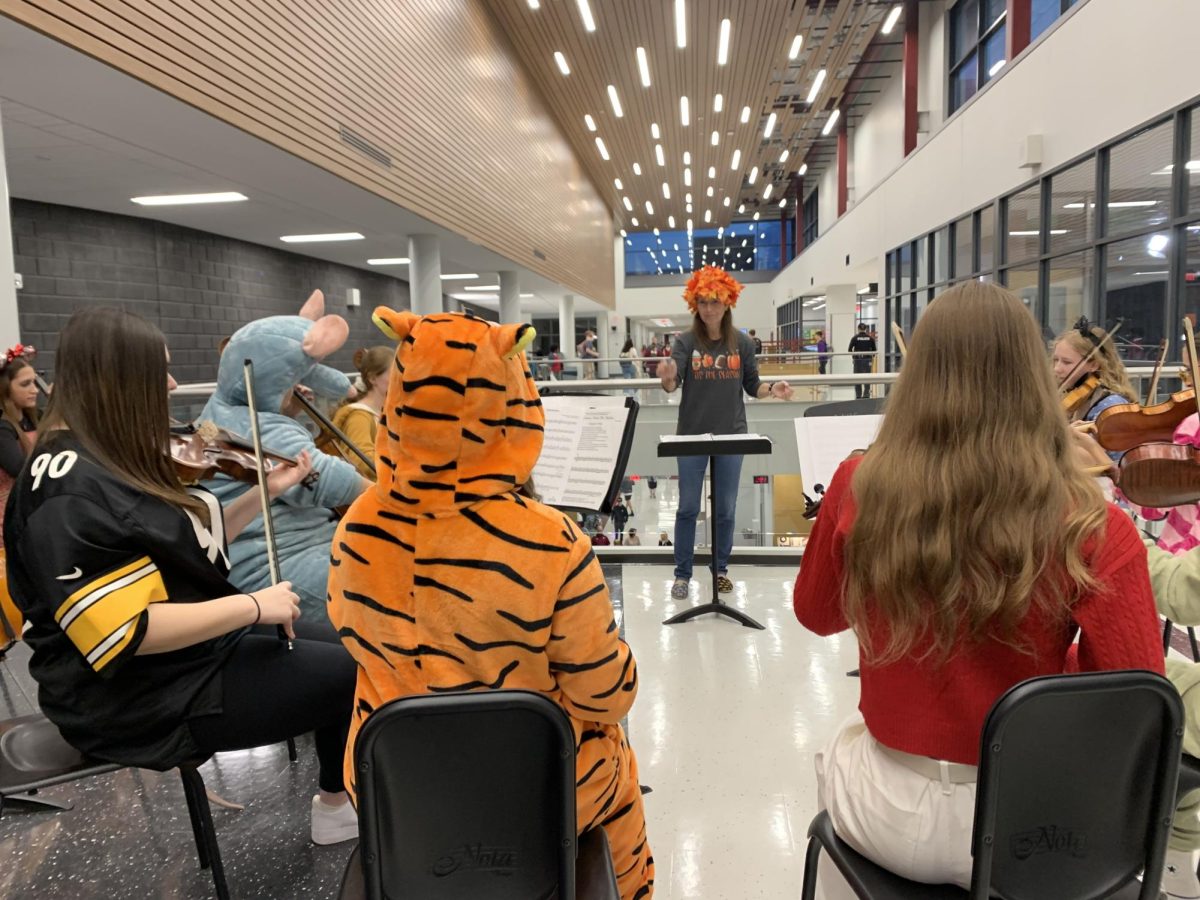 Spooky season. Orchestra director Kelly Detwiler conducts the String Ensemble on Thursday, Oct. 31 during morning security checks. The ensemble played holiday classics like "Thriller."