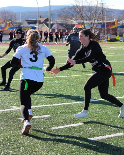 Hard at work. Poultry in Motion junior player Adelyn Himmelwright goes to grab senior Mya Mielnik's flag during the semi-finals. Poultry in Motion took home the championship title for the 2024 Turkey Bowl. 