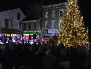 Lights Ignite! Community members gather around the towering evergreen during the Winterfest Tree Lighting ceremony. The event will be held at 5 p.m., the day after Thanksgiving. (Photo courtesy of Melanie Ramsey)