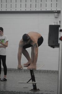 Dive in. Sophmore Seth Beere takes his stance to get ready to compete in his race. The boys team lost on Dec. 6. 