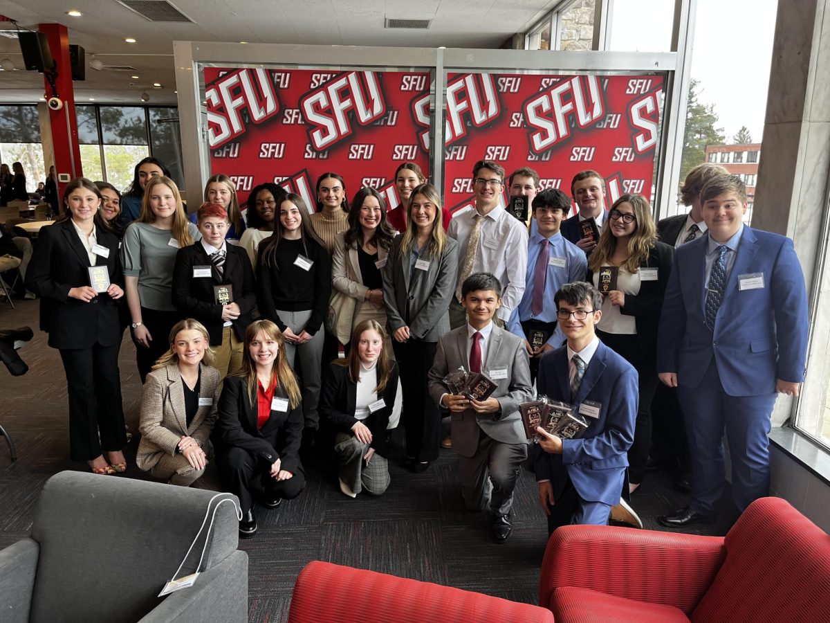 Last year's FBLA team takes time for a photo at the Regional competition at Saint Francis.