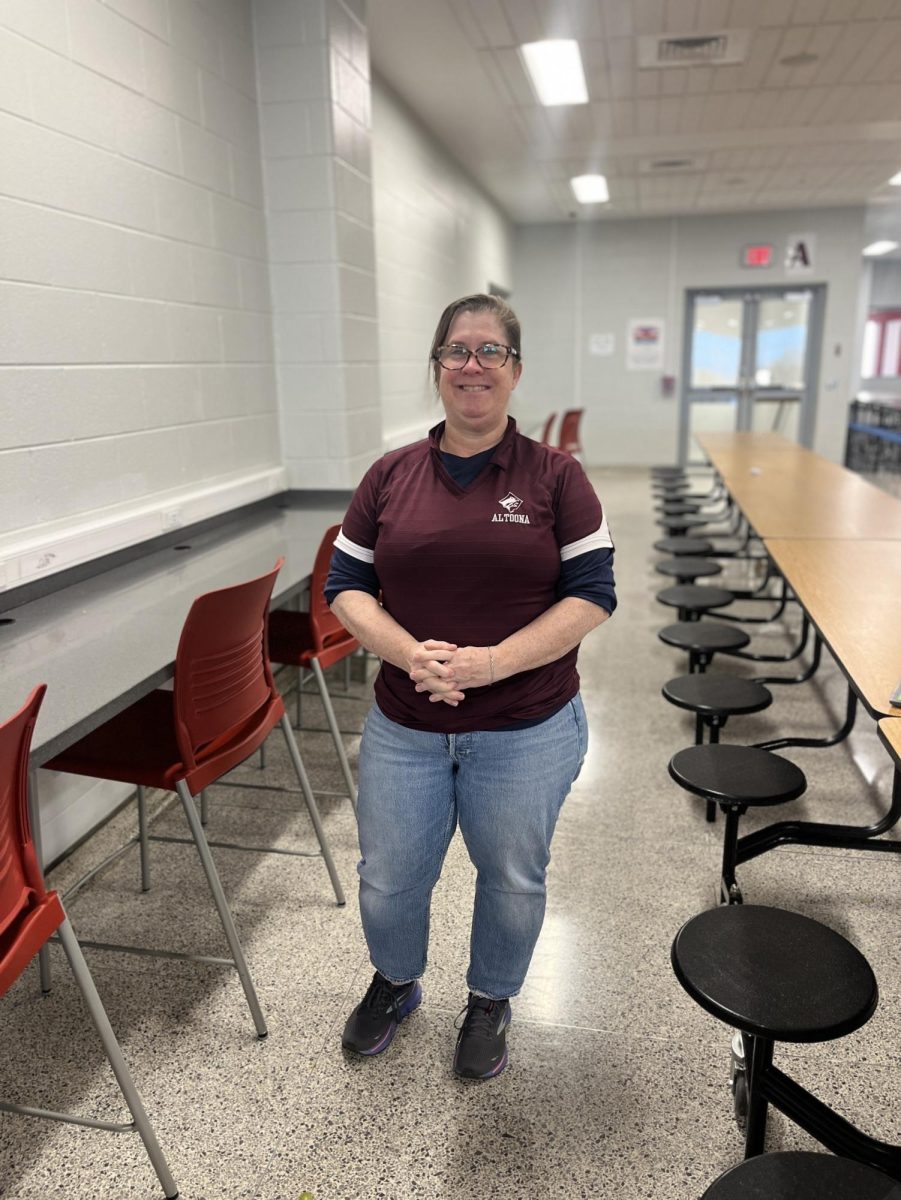 Mrs.Condo stands proud in her maroon and white attire.