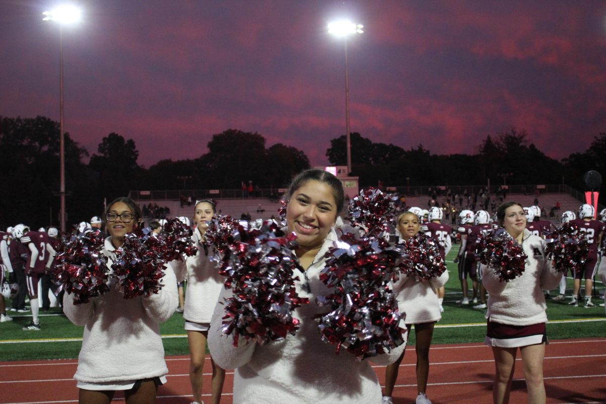 Cheering for the win. Cheerleaders perform during the annual Homecoming game. 