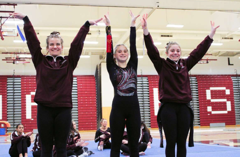 Gymnasts show off their awards at a meet last season. The team will compete in their first home meet on Dec. 18. (Courtesy of Jaidyn Palladini)