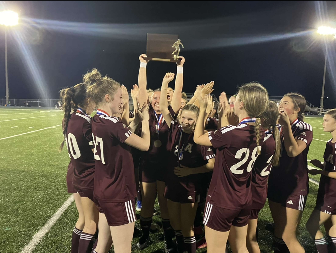 Altoona Lady Lions cheering after receiving their award. Senior Alannah Irwin to the left.