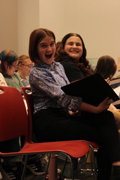 Juniors Camile Krug and Samarra Wertz
practice "Kiss the Girl" during rehearsal, but take a minor break to pose for the camera. 