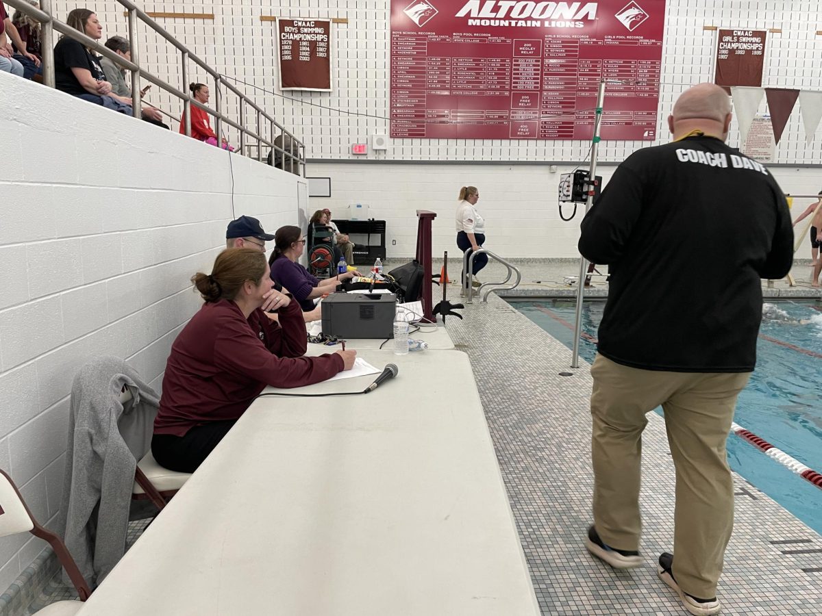 Helping hands. Volunteers like biology teacher Deneie Condo help to record scores, announce and more. 