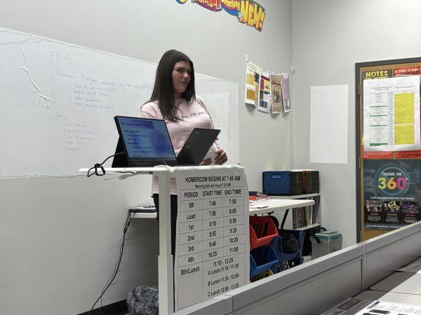 Talking business. Freshman Emma Hovan practices her FBLA presentation. Hovan practiced her sales presentation for products from Bath and Body Works.