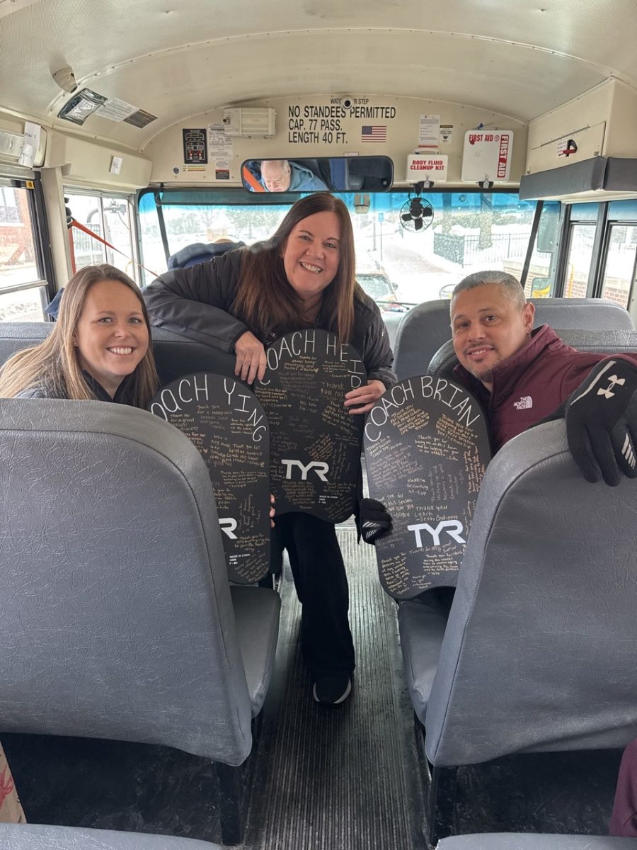 Swimmers presented the coaches with a memento on the way to the district meet. 