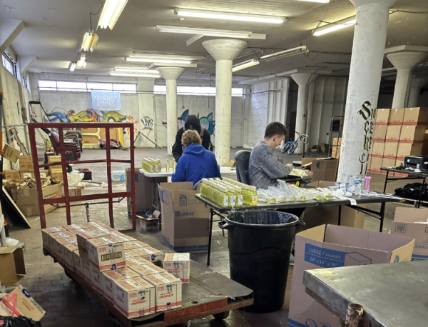 Hard at work. Seniors Matthew Harkins and Jace Baronner work in senior Charles Romanowicz's warehouse. The group uses Amazon FBA as an opportunity for side income while enrolled in school. (Courtesy of Charles Romanowicz)