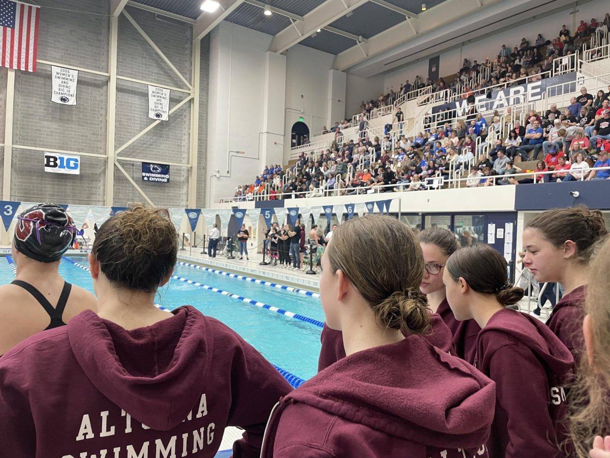 Swimmers wait to cheer for their teammates. 