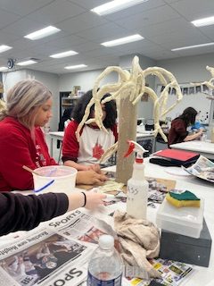 Juniors Cece Gibson and Amiri Clark sculpt with newspapers to create their tree. 