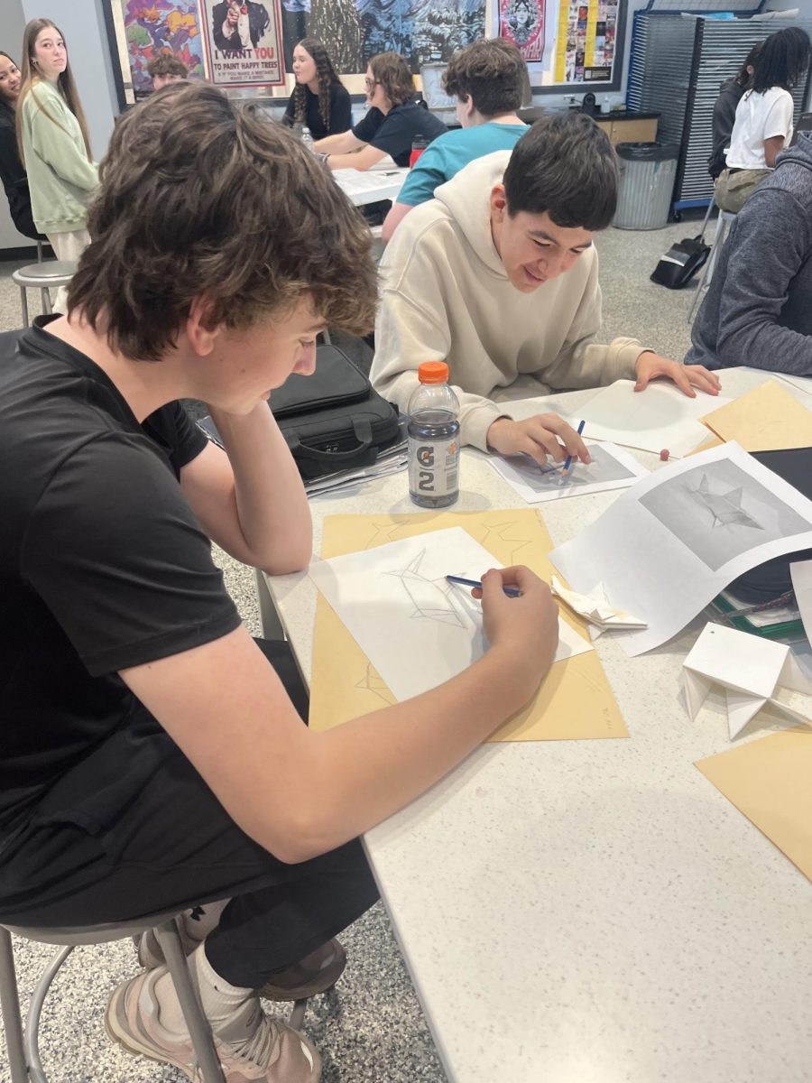Freshmen Spencer Akins and Kasen Sweeley stay focused while working on their projects in art class.