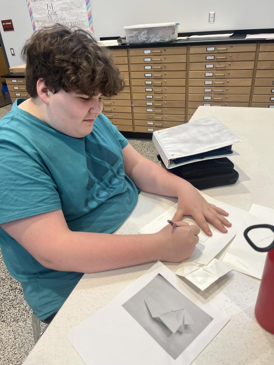 Freshmen Xavier Termin works hard on his art project.