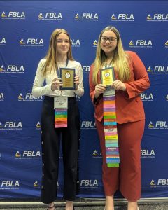 State placers. Seniors Courtney Irwin and Charlie Kephart gather together after the awards ceremony at Hershey Park. Irwin placed ninth in Economics and Kephart placed eighth in Journalism. (Courtesy of Wanda Vanish)