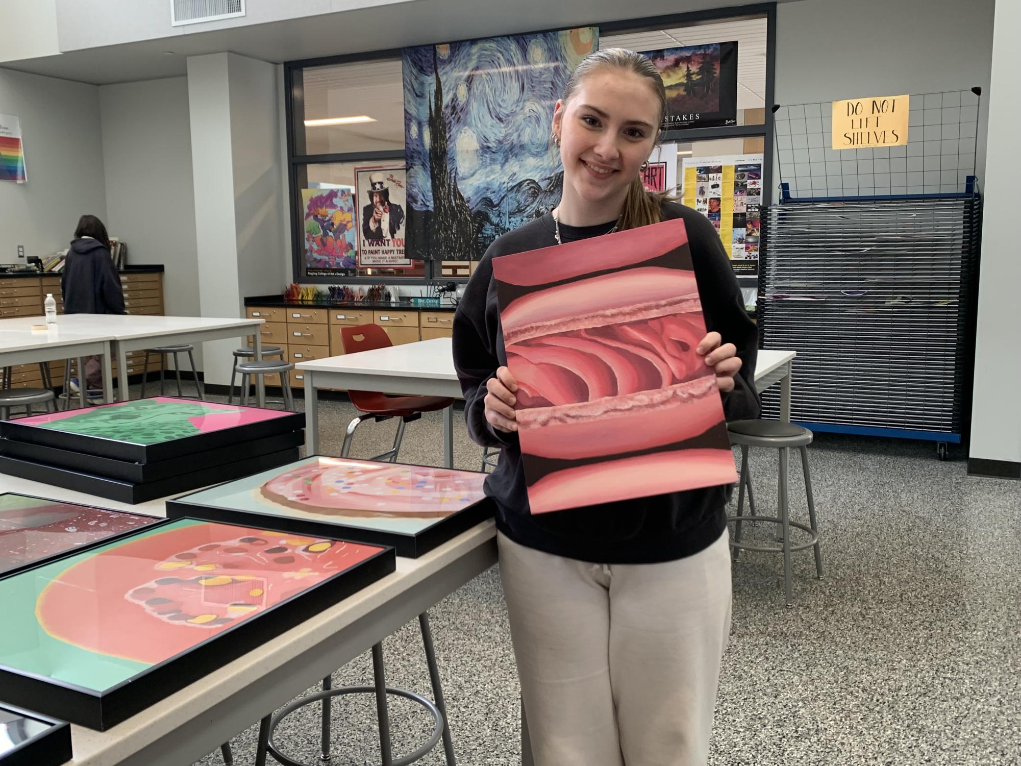 Sweet treat. Sophomore Emma Lang shows a piece of artwork she made in Curry's class.