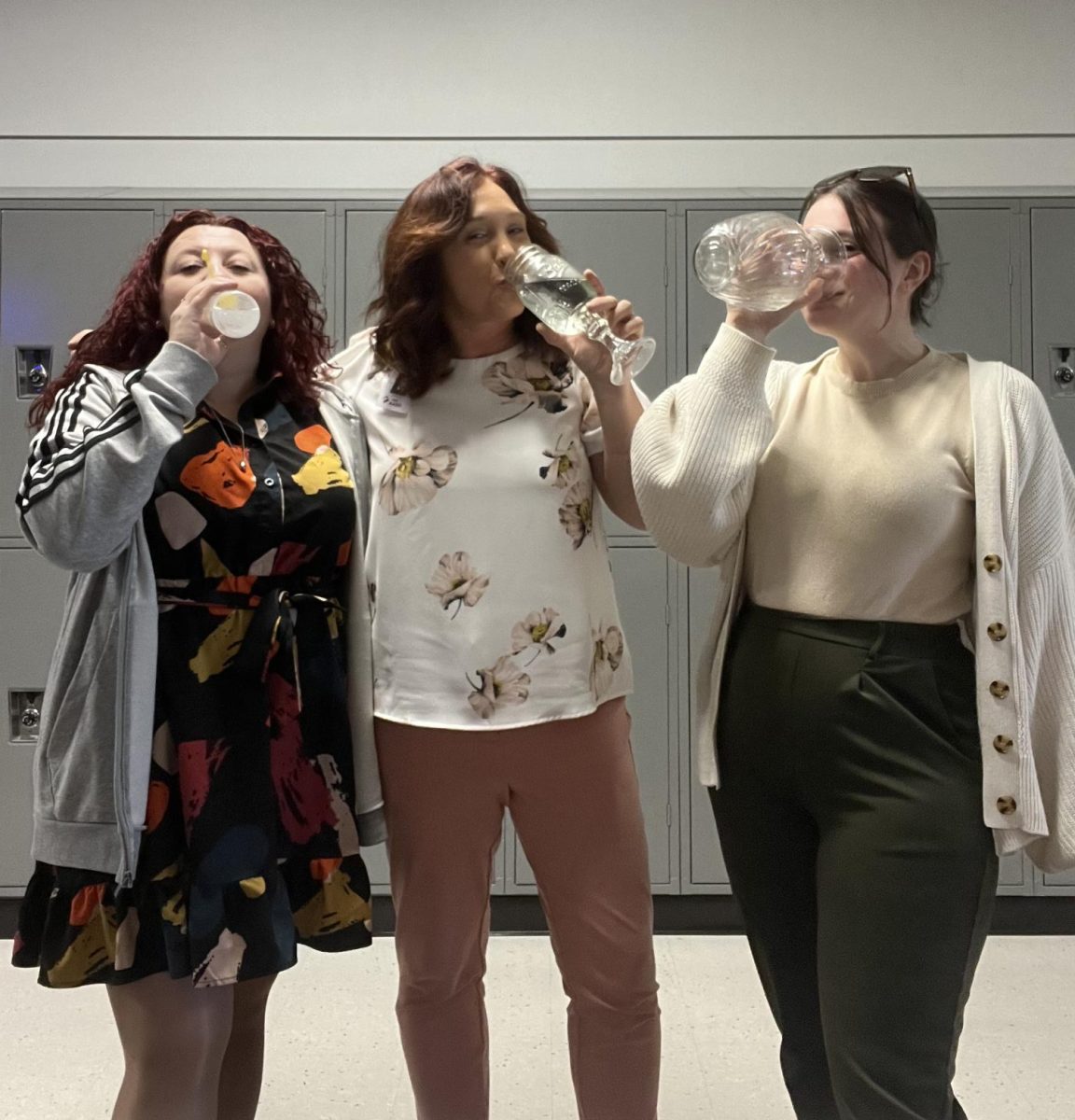 Theme day. Teachers pose taking part in the "Drink Out of Anything Besides a Mug Day". Kline encouraged all teachers to take part in the themes during this week with her. 