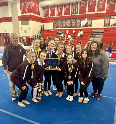 Victory. The gymnastics team mark another state Championship. Biseli coached them through both of these wins. (Courtesy of Zoe Weaver) 