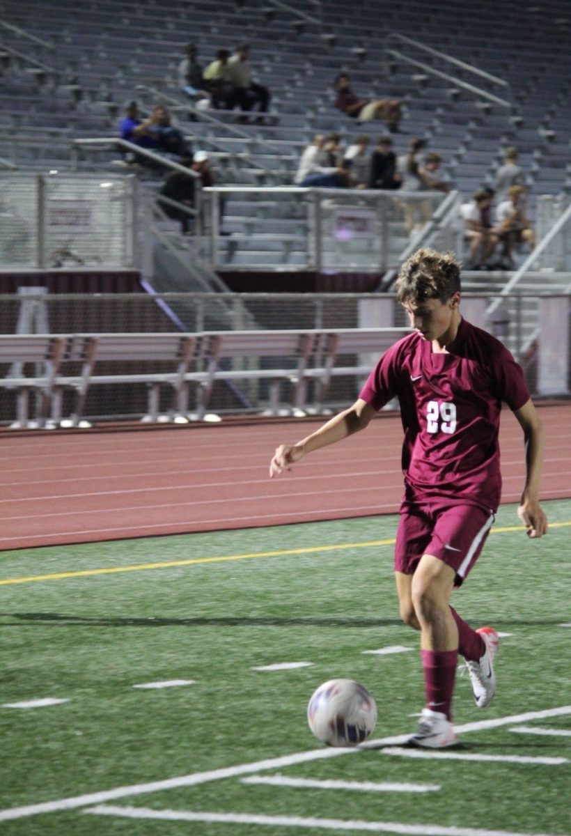 Dribble down. Guillermo Mejias dribbles down the sideline approaching the goal. Meijas joined the boys' soccer team as a foreign exchange student.