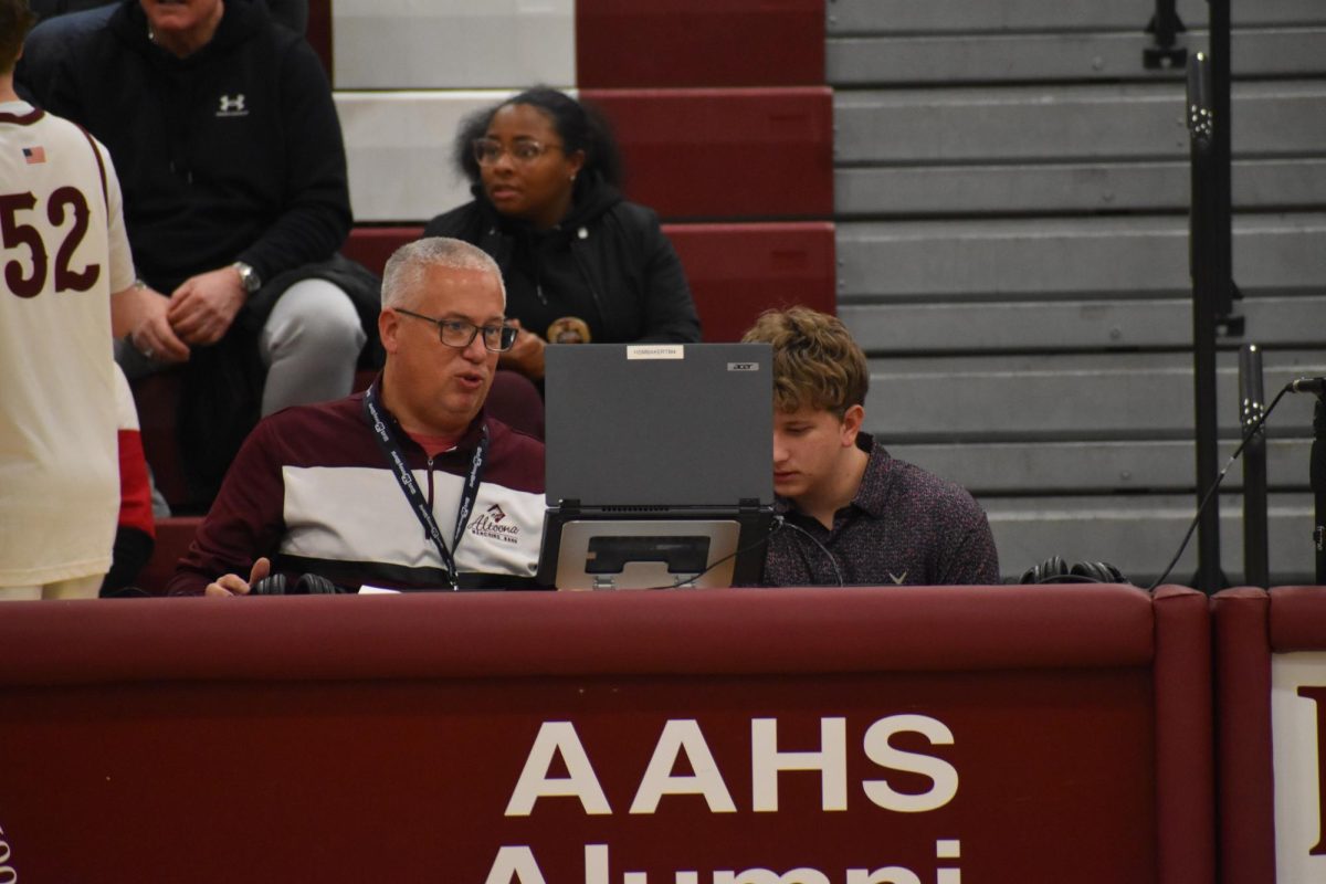 Game Time! Mr Baker helps set up the live broadcast for the basketball game.