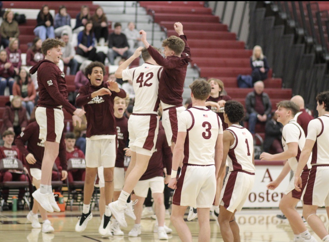  High jump. The basketball team jumps up after junior Eliott McCloskey runs through the tunnel during the starting lineup. This move serves as McCloskey's pregame hand shake. 