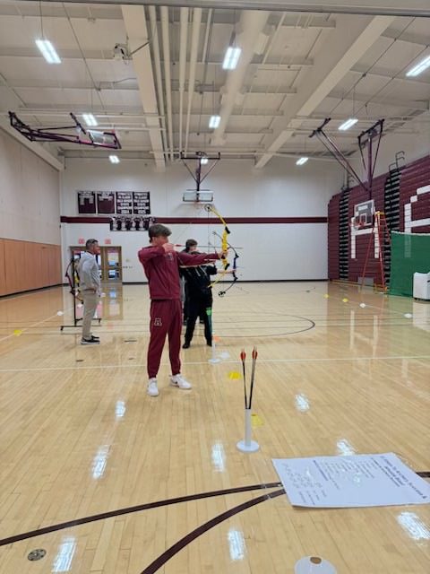 Aim. Students in the gym classes practice their form during their respective archery lessons. 