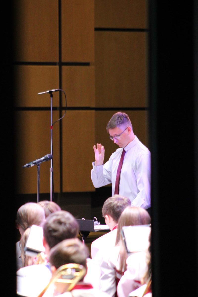 Loud and proud.  Ian Brannan, the junior high band director, leads the band  during the concert. This is Brannan's first year at Altoona. 