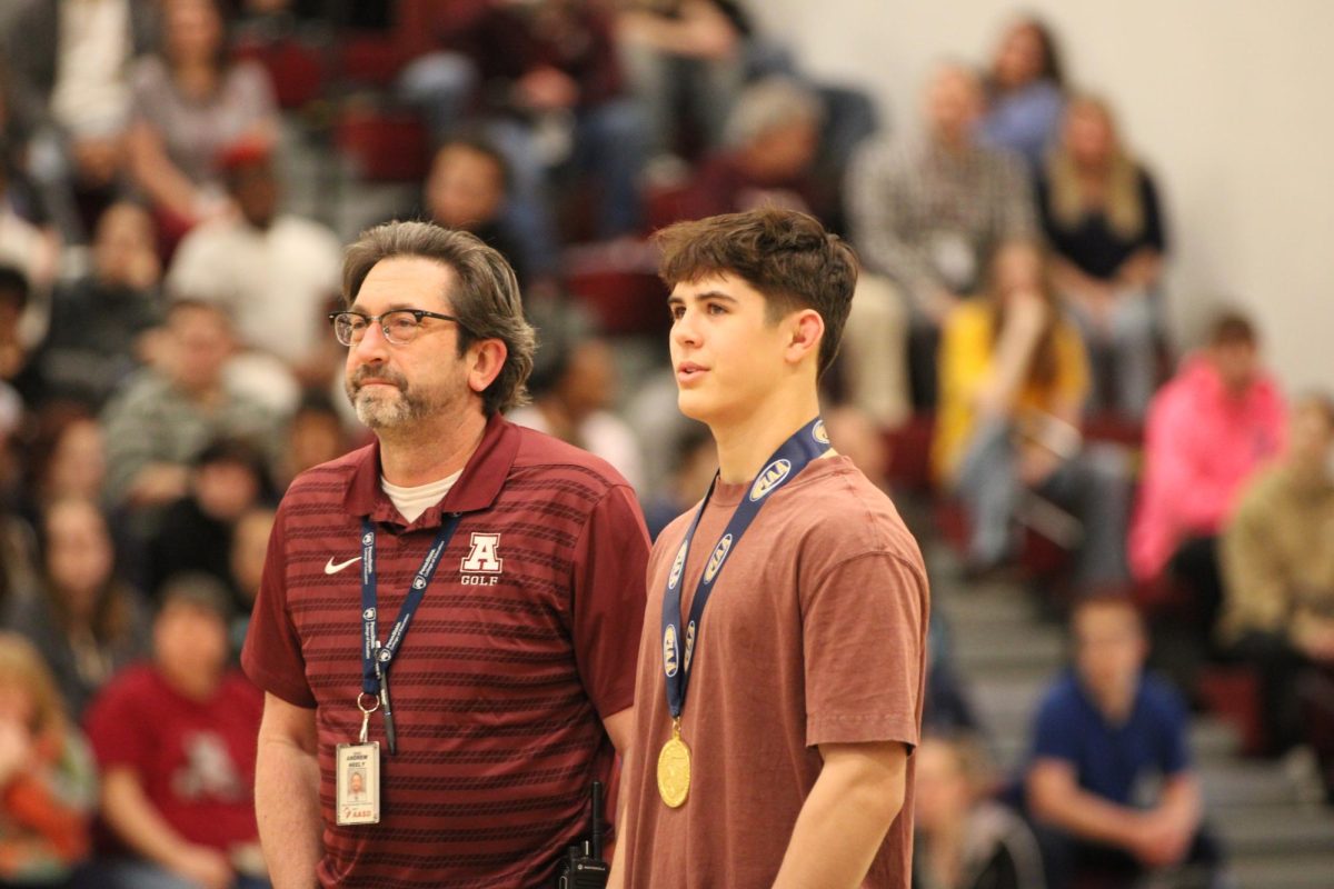 Throwdown. Head principal Andrew Neely and Ciampoli rewatch the moment where Ciampoli became state champion in the gym packed with students. Wrestlers with state and district titles were recognized at the school-wide pep rally on March 10. "All of my practice partners... [have helped me attain this]," Ciampoli said. "I've worked hard with all of them, and I'm pretty grateful to have them on my team."
