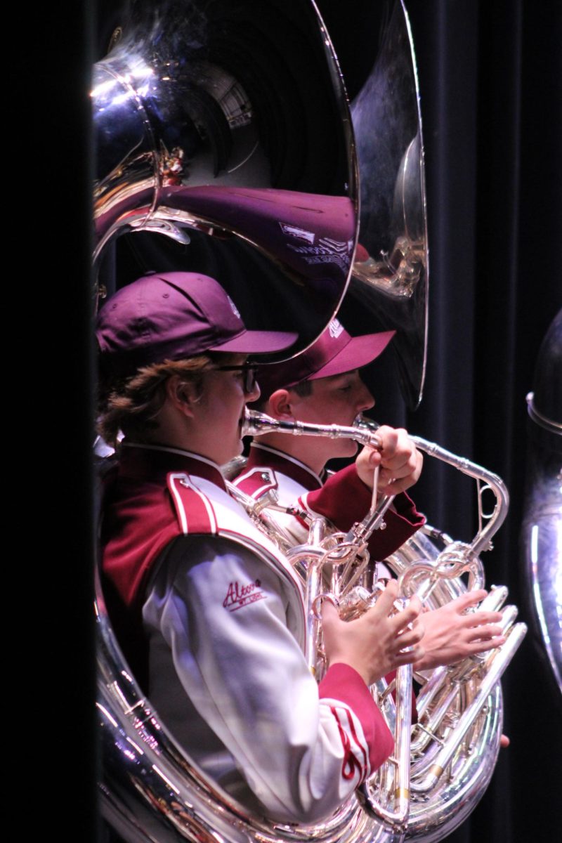  In sync. Senior Andrew Sackett focuses on Drum Major Gracelynn Beldin during the Pregame portion of the Bandarama concert. 
