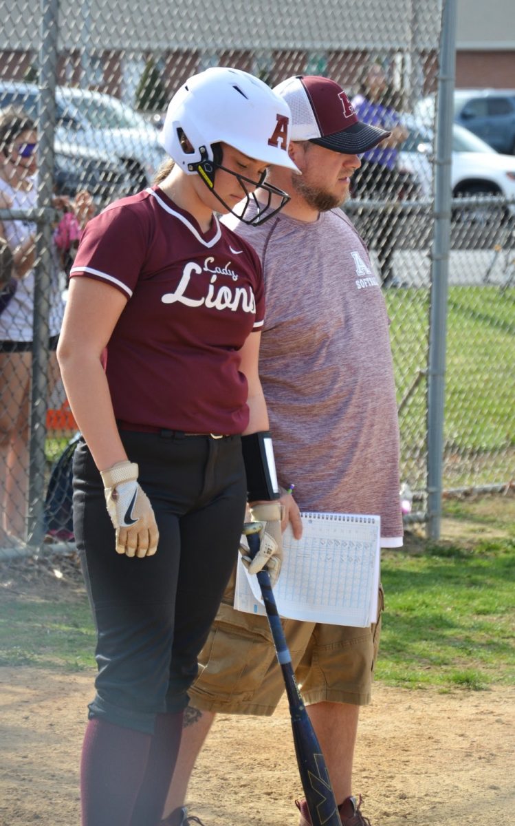 Jv head coach Terry Rowles gives freshman Katie Beck a pep talk before she steps up to the plate to bat. 