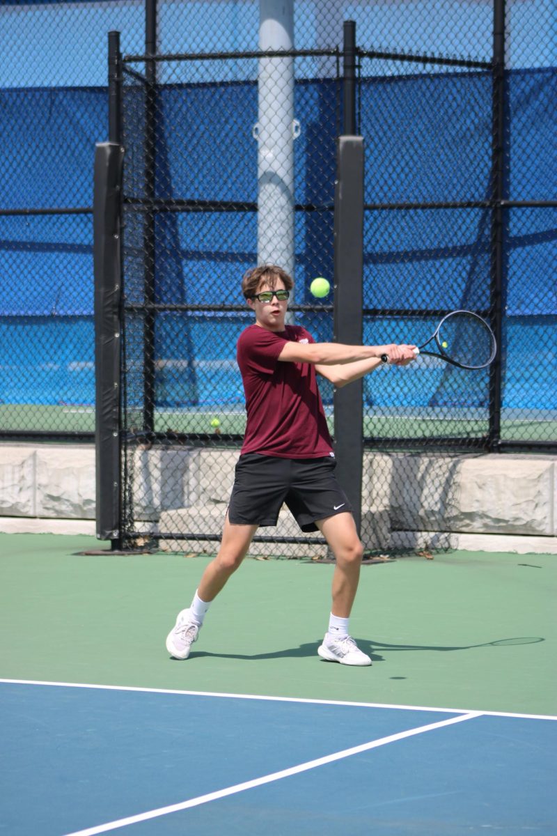 Game, set, match. Freshman Thomas Orr backhands a ball put into play by his opponent. "I was really trying to focus more on the ball, but I was also keeping my upper body, my right leg, more stabilized as I jumped,"  Orr said.
