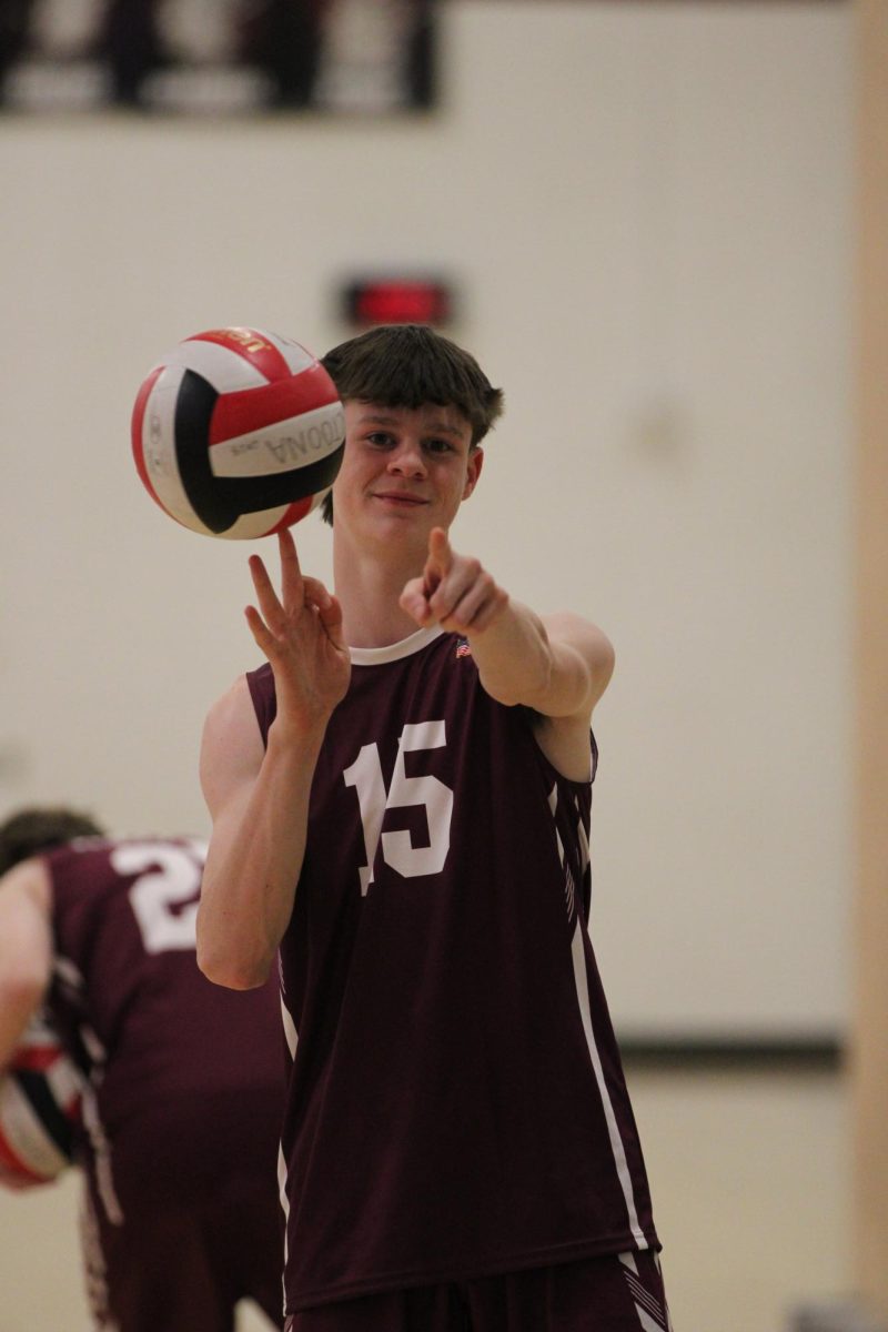 Strike a pose. Sophomore Owen White poses for a photo while the team warms up for their game. 