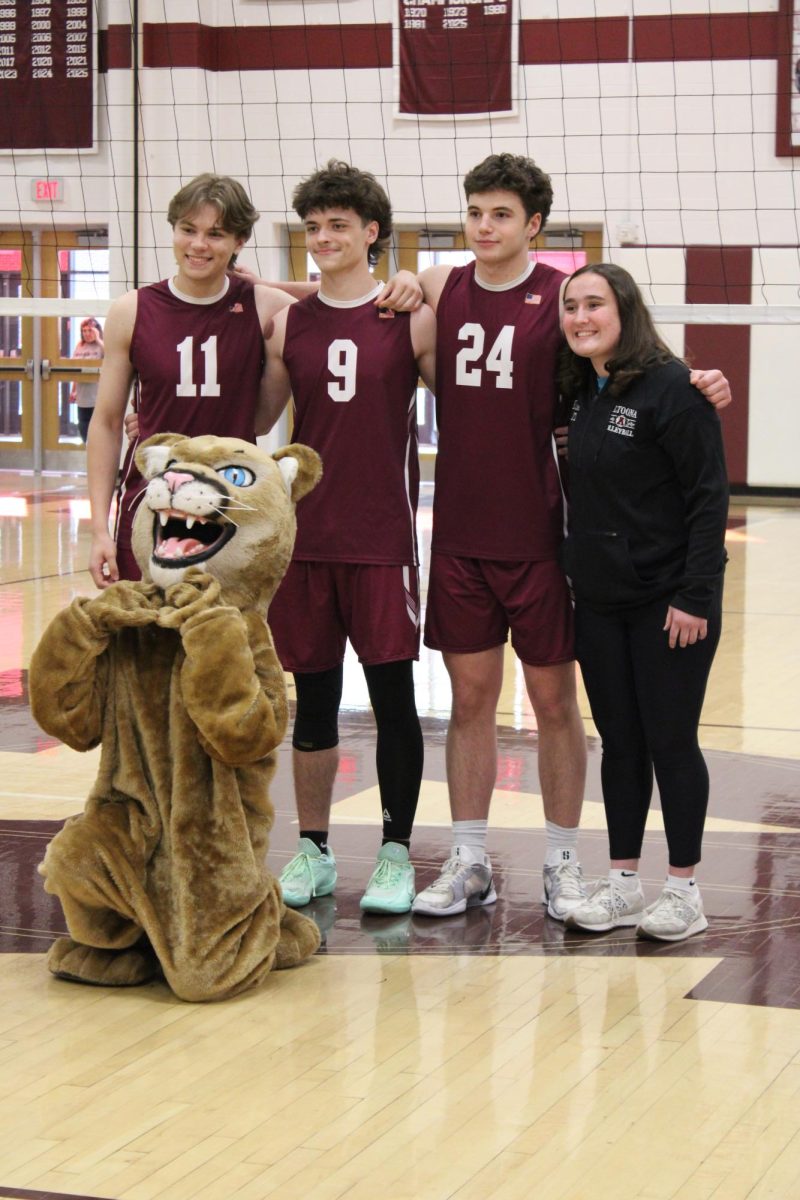 The final four. Seniors Caleb Terza, Parker Huey-Kish, Noah Diventura and Maraya Bittner come together with the mascot to take a photo during their senior night.